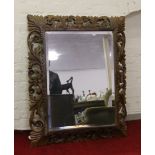 A large carved oak bevel edge wall mirror.