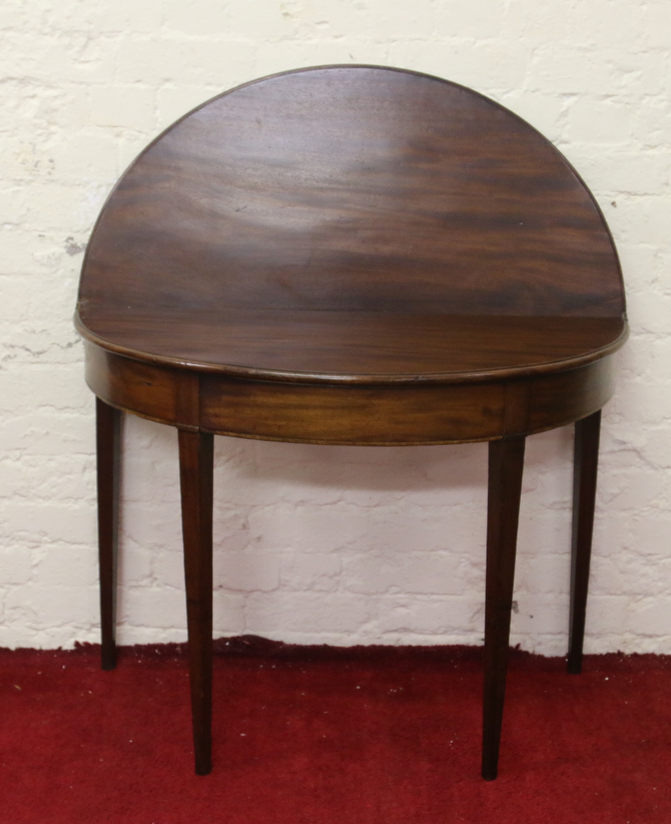 A Victorian mahogany fold over demi lune side table raised on tapering supports. - Image 2 of 2
