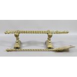 An ornate brass fireside companion set with rope twist decoration and a pair of similar stands.