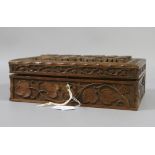A carved hardwood workbox carved throughout with leaves and berries.