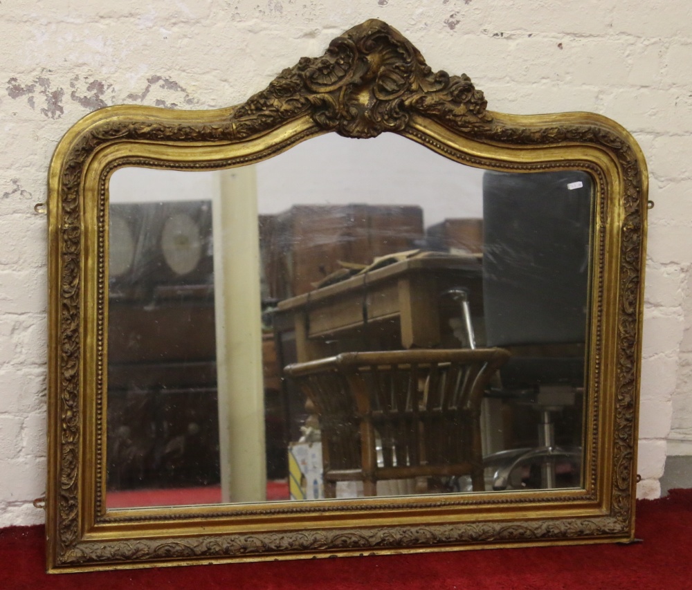 A large ornate gilt framed overmantle mirror.