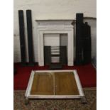 A cast iron fire surround and insert together with a range surround and a pair of Georgian cupboard