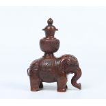 A nineteenth century Tibetan copper scented oil container. Formed as an elephant holding a lidded