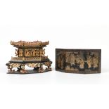 A Vietnamese lacquered cake box. The cover, decorated in gilt with figures, opens to reveal a carved