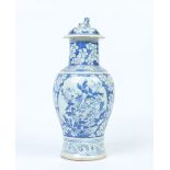 A Chinese baluster jar and cover. Painted in underglaze blue with a ground of blossom and panels