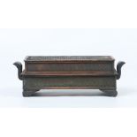 A twentieth century Chinese copper incense burner of rectangular form, with twin handles and