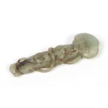 A Chinese open carved jade handle, of scrolling form incorporating a bat and mythological catlike