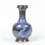 A twentieth century Chinese bottle vase of Kangxi style. With silvered ground and painted in