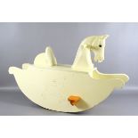 A childs painted wooden rocking horse.