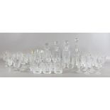 A collection of cut glass decanters and matching lead crystal wine glasses and tumblers, etc.