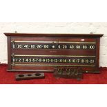 A Victorian snooker score board and a mahogany cue rack with brass mounts.