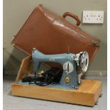 A cased Alfa electric sewing machine.