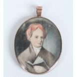 A Georgian mourning pendant in engraved yellow metal mount and set with an ivory portrait