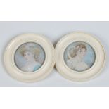 A pair of ivory framed circular portrait miniatures of women, 9cm overall diameter. Condition