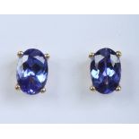 A pair of 18 carat gold and tanzanite threaded stud earrings. With oval faceted stones, total 1.