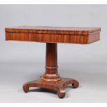 A Regency walnut fold over tea table. Raised on a spreading octagonal column over a scrolling