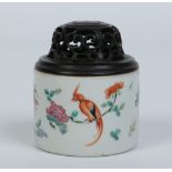 A Chinese famille vert small pot pourei jar with pierced hardwood cover. Painted with blossoming