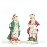 A small pair of Rockingham figures. Modelled as a Turk and his companion, painted in coloured