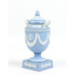 A nineteenth century Wedgwood solid jasper twin handled urn and associated cover. Decorated with