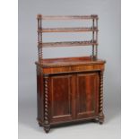 A Victorian rosewood single drawer chiffonier with a three tier book shelf top raised on barley