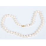 A white cultured pearl necklace with 18 carat gold clasp. 47cm, pearls 8mm. Condition Report. To