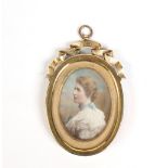 A Victorian ivory portrait miniature of a lady in gilt brass frame having scroll capital inscribed