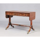 A Regency mahogany two drawer sofa table. With turned cross stretcher and raised on scroll supports,
