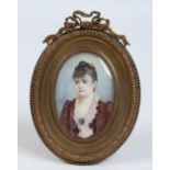 An early twentieth century portrait miniature in gilt brass strut frame. Portrait of a woman