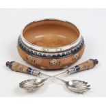 A Doulton Lambeth stoneware salad bowl and servers with silver plated mounts. Having ribbed