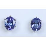A pair of 18 carat white gold stud earrings each set with a faceted ovoid tanzanite stone. Stones