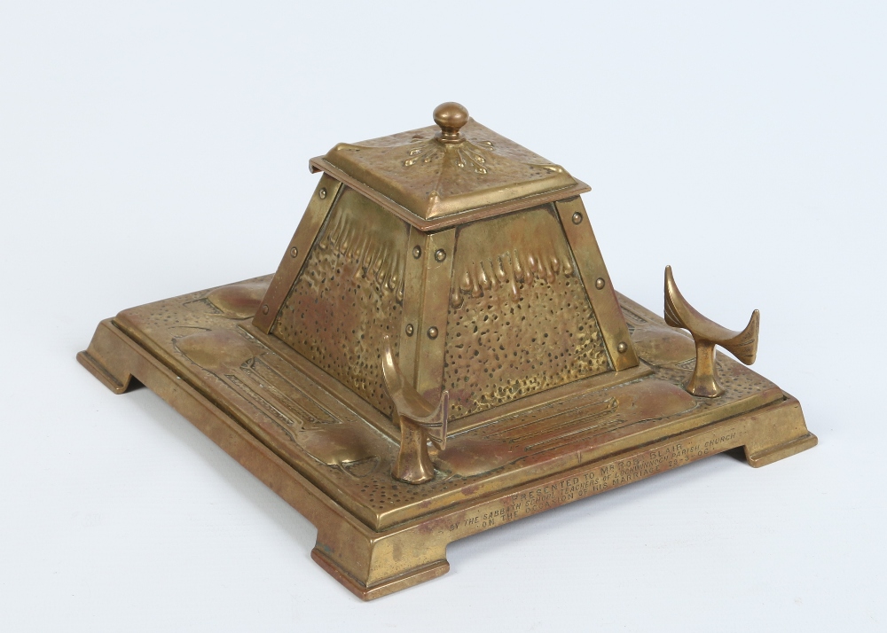 An Art Nouveau gilt bronze desk stand of stylized square form. With hinged inkwell and raised on