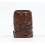 A Chinese carved bamboo bitong. Decorated with stylized leaves and raised on a rockwork base,