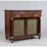 A Regency rosewood secretaire chest. With brass inlay and raised over a cupboard base with grill