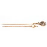 A 15 carat gold stick pin set with an opal and a 10 carat gold stick pin set with a diamond and