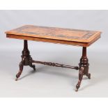 A Victorian figured walnut twin pillar library table. With marquetry inlay and raised on carved