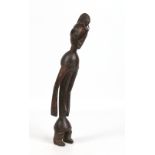 A tribal African carved hardwood figure of a man with elongated arms, 51cm.