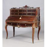 A fine nineteenth century French rosewood bombe shaped desk. With carved openwork scrolling gallery,