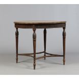 An Edwardian mahogany circular centre table. With reeded frieze and raised on slender tapering