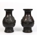 A pair of large Japanese Meiji period patinated bronze vases on stands. With overlay decoration
