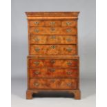 A Queen Anne figured walnut chest on chest. With concealed drawer to the moulded frieze,