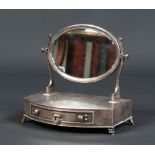 An Edwardian silver novelty trinket box formed as a single drawer bow fronted dressing table mirror.