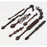Seven carved hardwood folk art love spoons in the Welsh style. With carved decorations and one