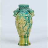 A Chinese baluster vase. With twin carp moulded handles, applied leaf and flower mouldings and
