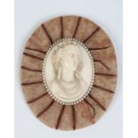 A nineteenth century European carved ivory portrait miniature depicting a young lady wearing a