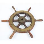 An antique oak and brass mounted small ships wheel, 42cm wide. Condition Report. To be used as a