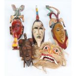 Five carved polychrome wooden tribal dance masks. Including four African examples and one Oriental.