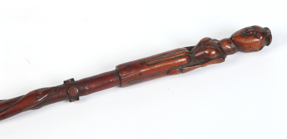 An African carved hardwood staff with wirework grip and carved to the top with a female figure in