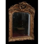 An eighteenth century gilt framed Continental hall mirror. With pierced pediment ornamented with