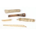 Three Inuit carved tools including marine ivory examples and a small model of a boat. Largest