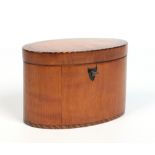 A Regency oval satinwood tea caddy. With cross hatched inlay, stringing and shield escutcheon,